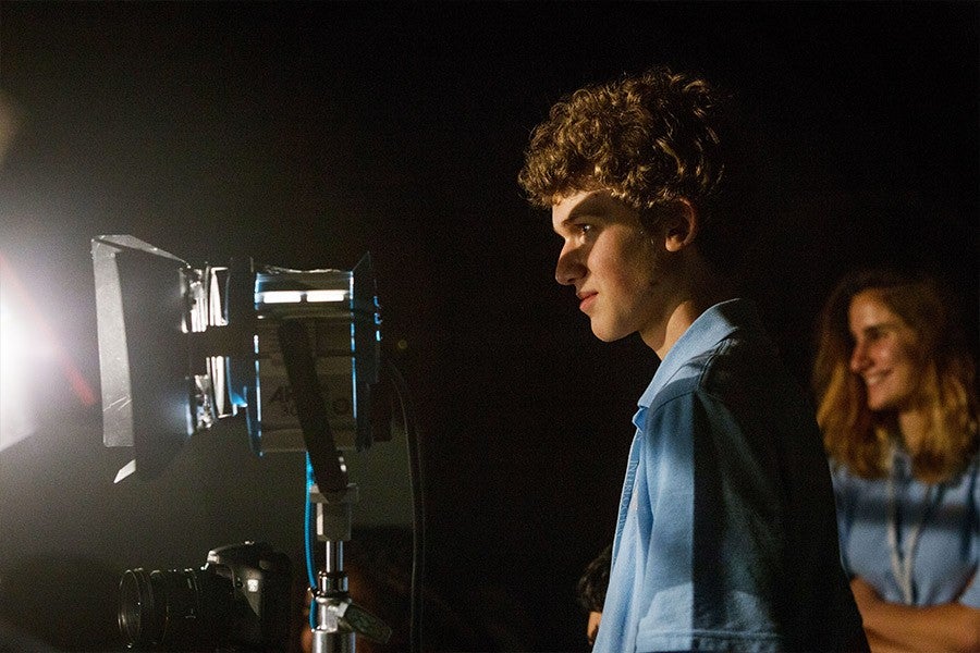 Student adjusts lighting during Film & New Media course at interlochen arts camp