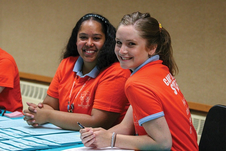 Staff checking in students at the start of camp