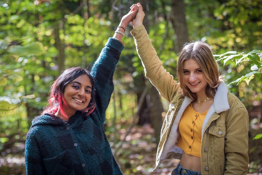 two interlochen arts academy students high fiving