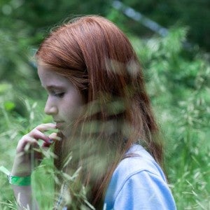 A girl in a field of tall grass