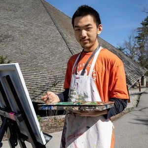 Bradom Zhang paints outside of Kresge Auditorium during the annual Run for the Arts 5K in May 2024.
