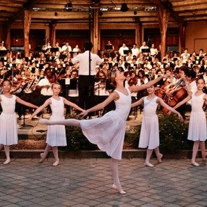 A group of dancers in front of an ensemble