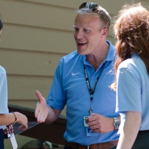 President Devey greets two junior girls during a Camp reception.