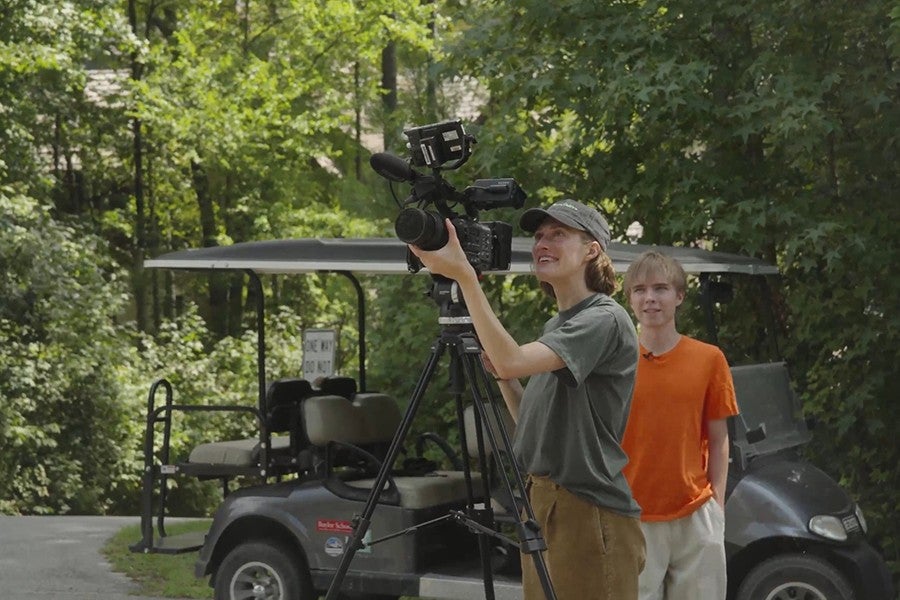 Claire Collins operates a camera while film student Cooper looks on.