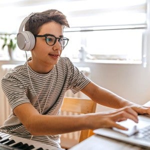 A boy working on a laptop computer