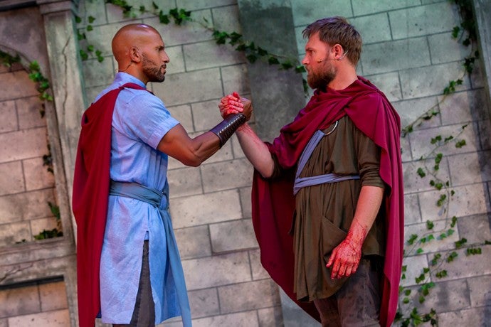 two men hold each others hand in a firm grip