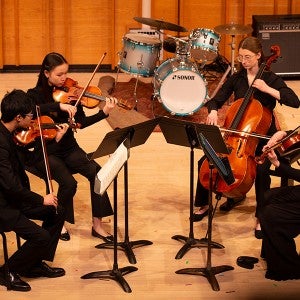 A student string quartet performs at Kaufman Music Center's Merkin Hall during the March 2024 partner tour. 