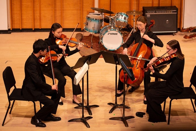 A student string quartet performs at Kaufman Music Center's Merkin Hall during the March 2024 partner tour. 
