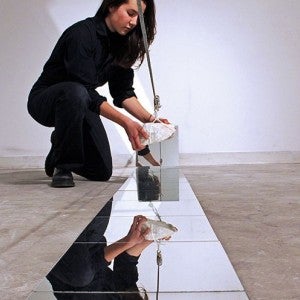 A visual artist sets up an installation