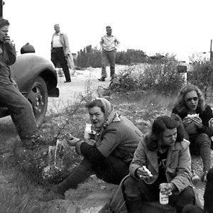 Faculty and staff picnic next to a bus
